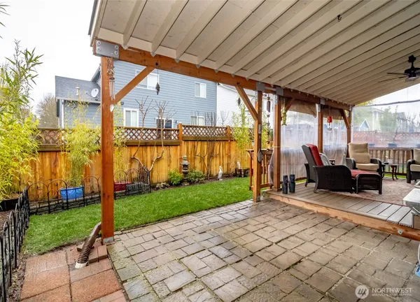 a view of a house with backyard and sitting area