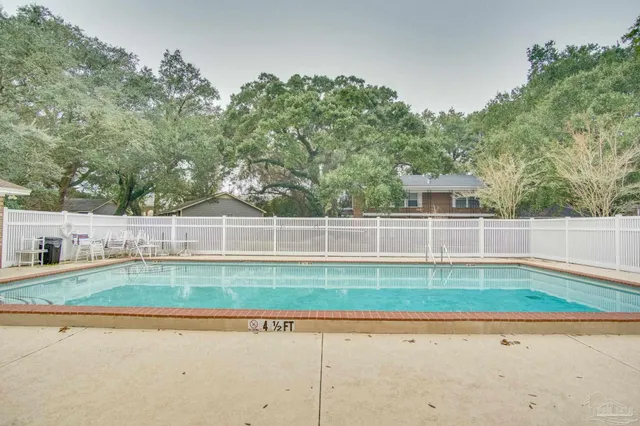 a white house with a yard and a swimming pool