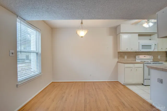 a view of a kitchen with a sink dishwasher and wooden floor