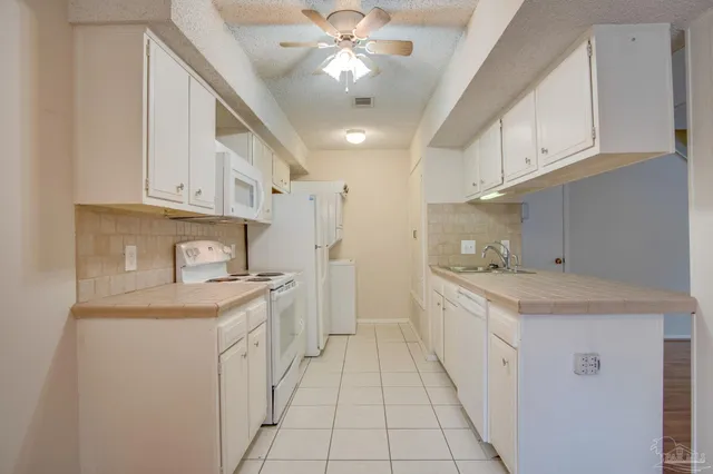 a kitchen with a sink window and cabinets