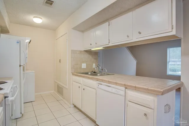 a kitchen with a sink and cabinets