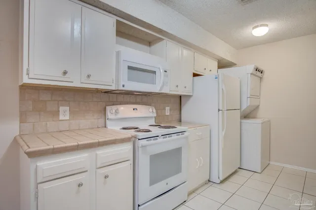a kitchen with appliances cabinets and a counter top space