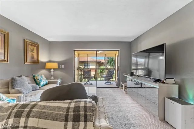 a bedroom with a bed and large windows