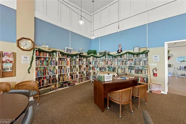 a dining area with furniture a wall clock and a rug