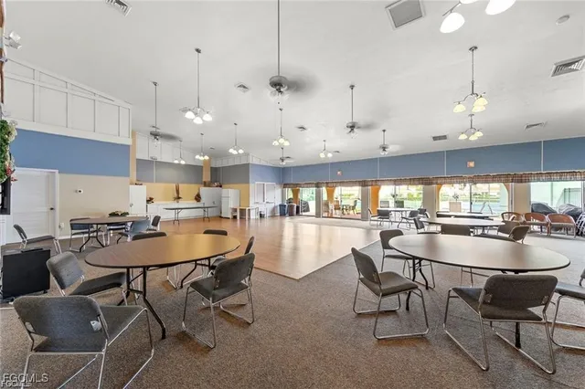 a dining room with stainless steel appliances kitchen island a table and chairs