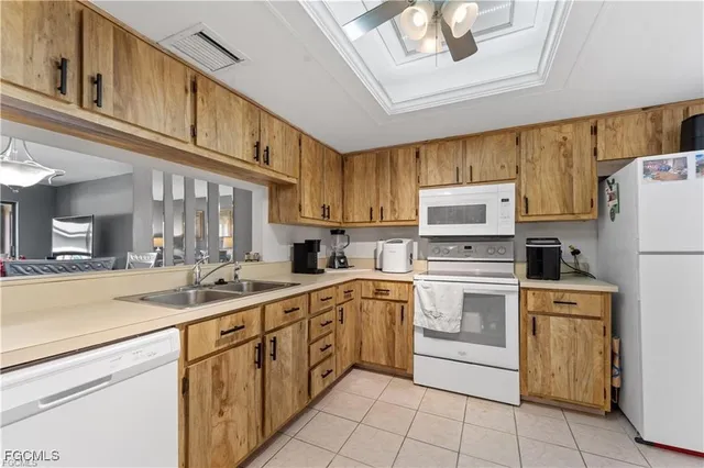 a kitchen with white cabinets sink and white appliances