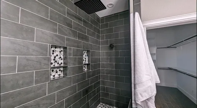 a bedroom with bed and a flat screen tv