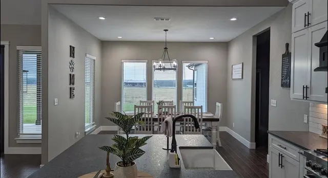 a stove top oven sitting inside of a kitchen