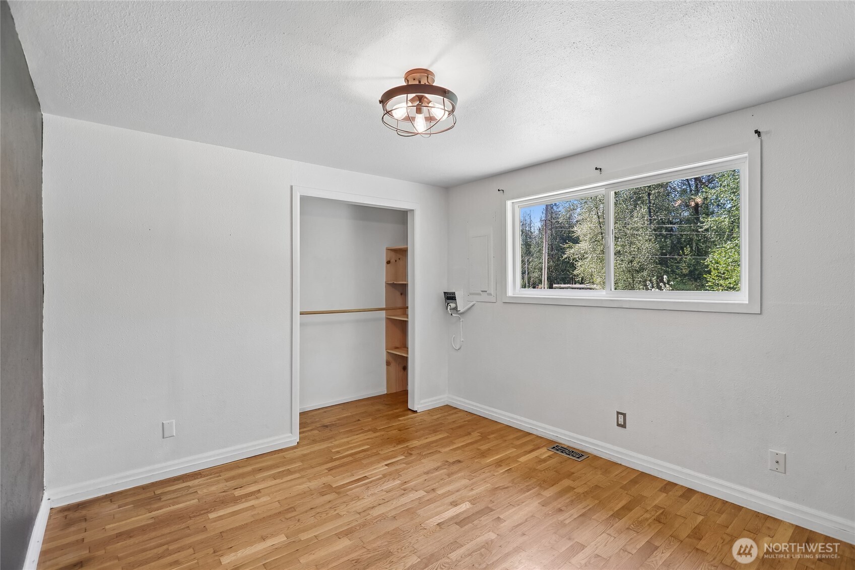 28601 Southeast 225th Street Maple Valley, WA 98038 - Photo 20 of 40 a view of empty room with wooden floor and fan