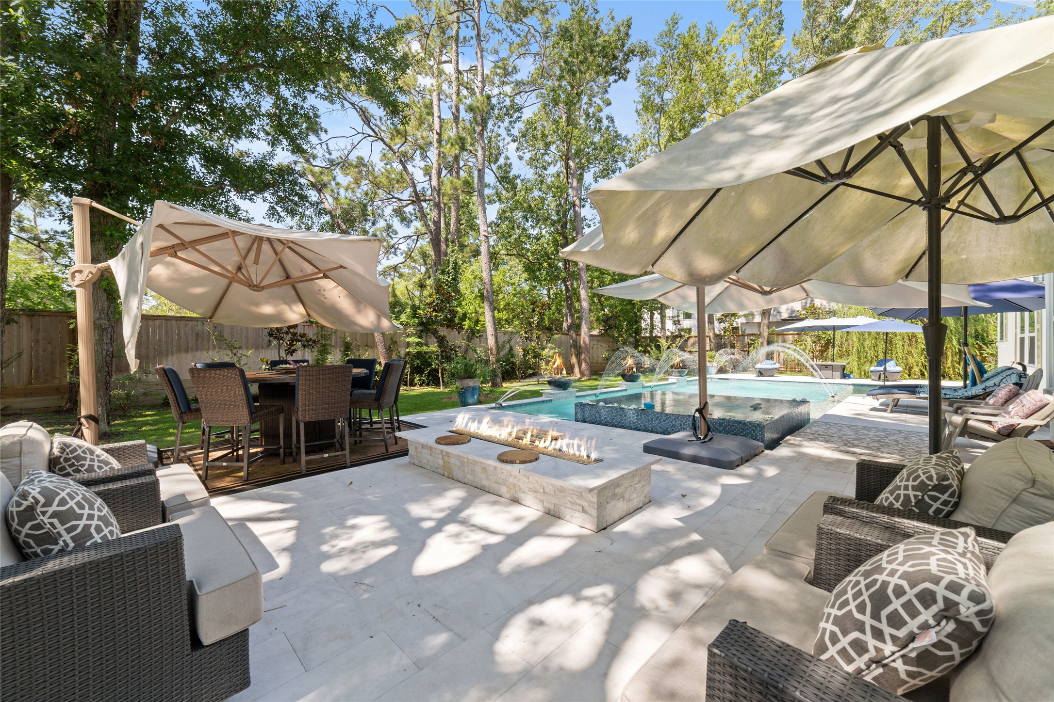 335 Voss Road Houston, TX 77024 - Photo 9 of 45 a view of a patio with couches and table and chairs under an umbrella
