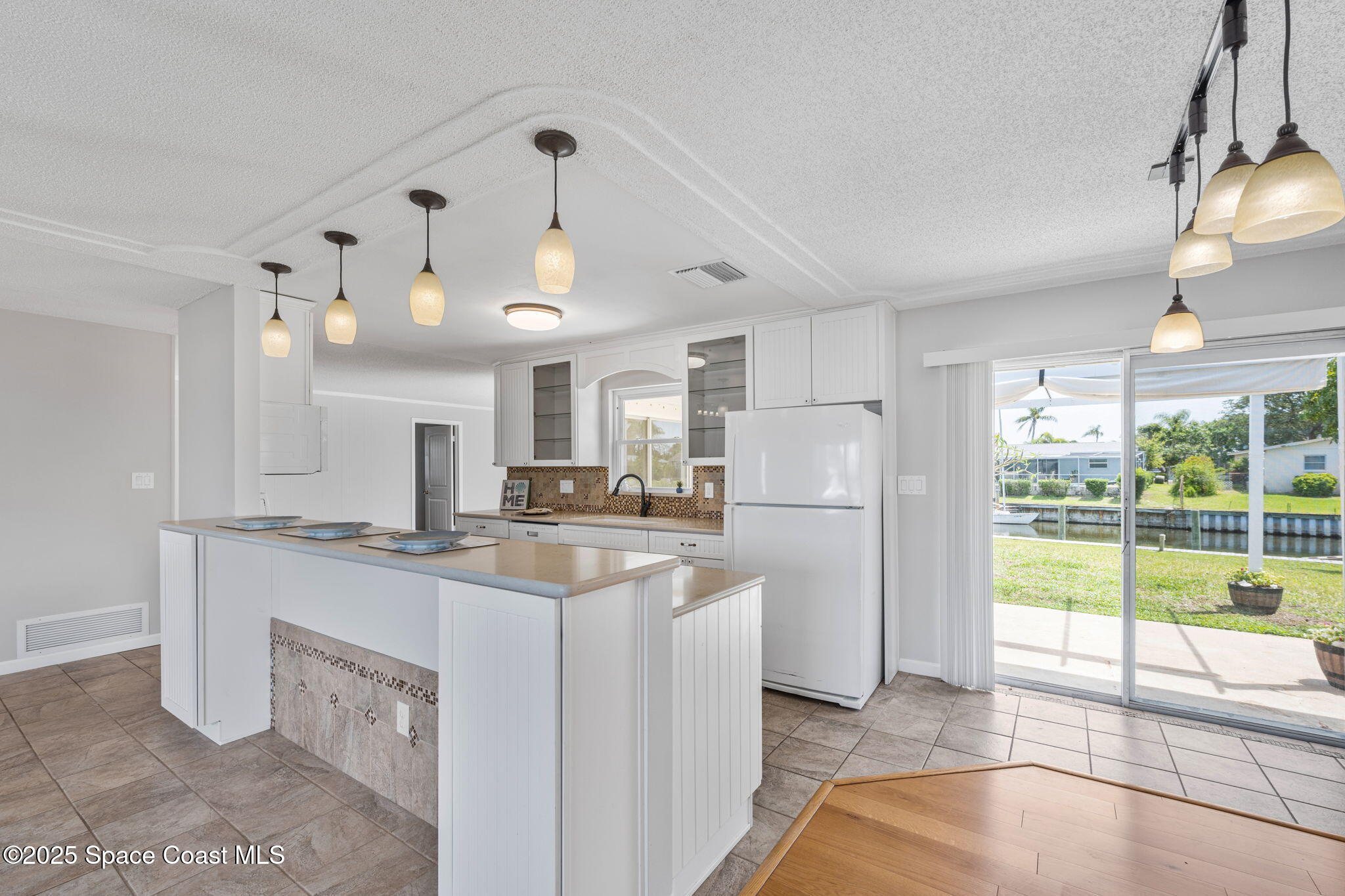 437 Eagle Drive Satellite Beach, FL 32937 - Photo 9 of 30 a kitchen with stainless steel appliances granite countertop a sink a stove and a refrigerator