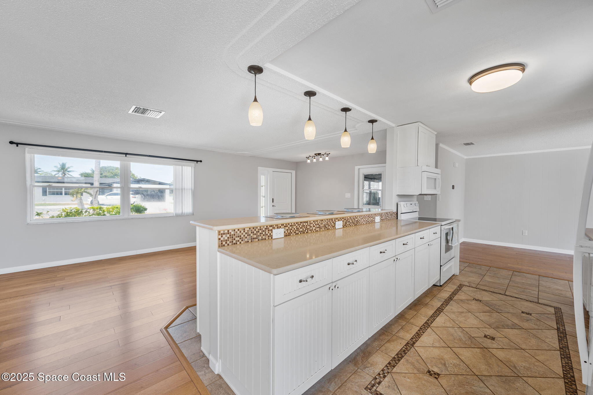 437 Eagle Drive Satellite Beach, FL 32937 - Photo 29 of 30 a large bathroom with a granite countertop sink a large mirror and shower