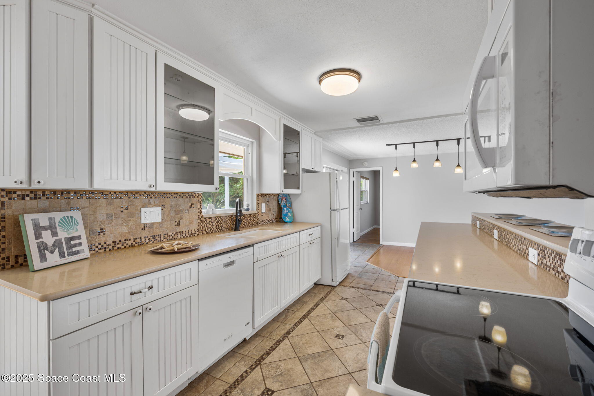 437 Eagle Drive Satellite Beach, FL 32937 - Photo 11 of 30 a open kitchen with stainless steel appliances granite countertop a sink and a stove