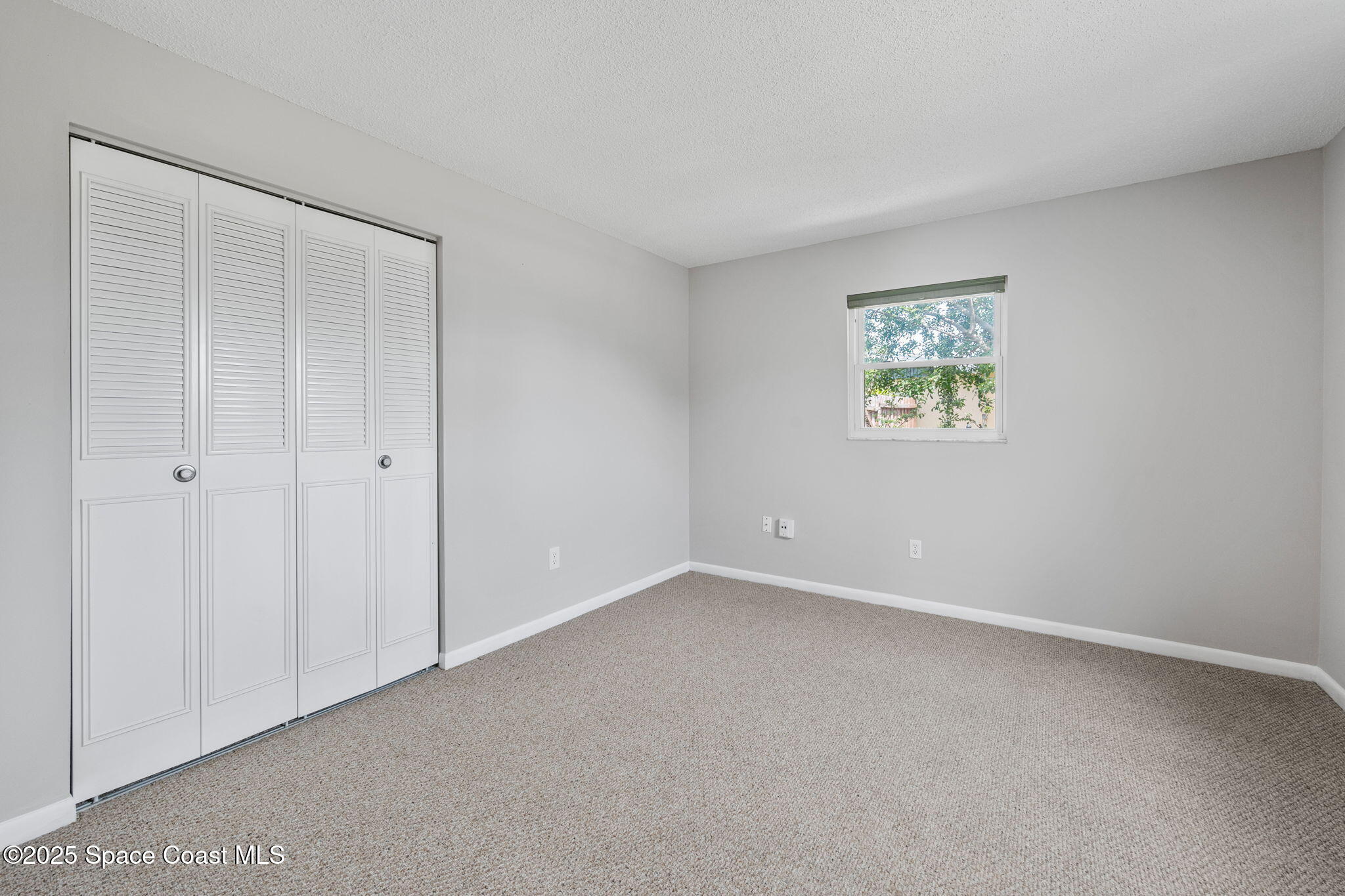 437 Eagle Drive Satellite Beach, FL 32937 - Photo 21 of 30 a view of an empty room with a window