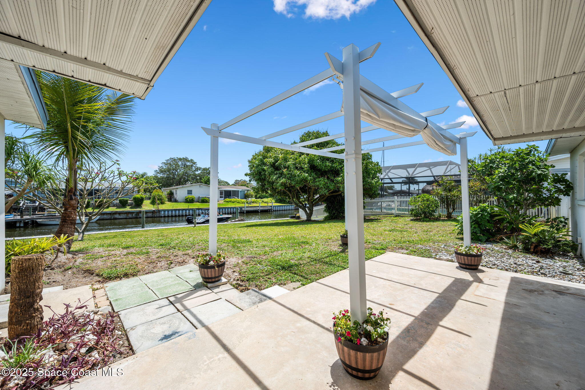 437 Eagle Drive Satellite Beach, FL 32937 - Photo 24 of 30 a house view with a sitting space and garden view
