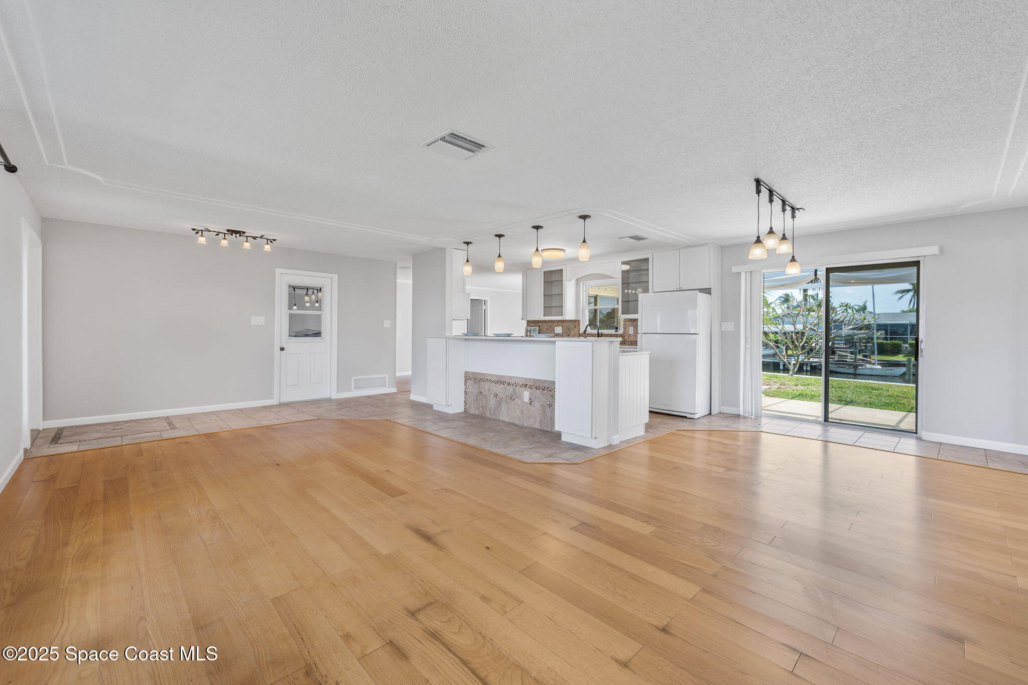 437 Eagle Drive Satellite Beach, FL 32937 - Photo 28 of 30 a view of a kitchen with wooden floor and a fireplace
