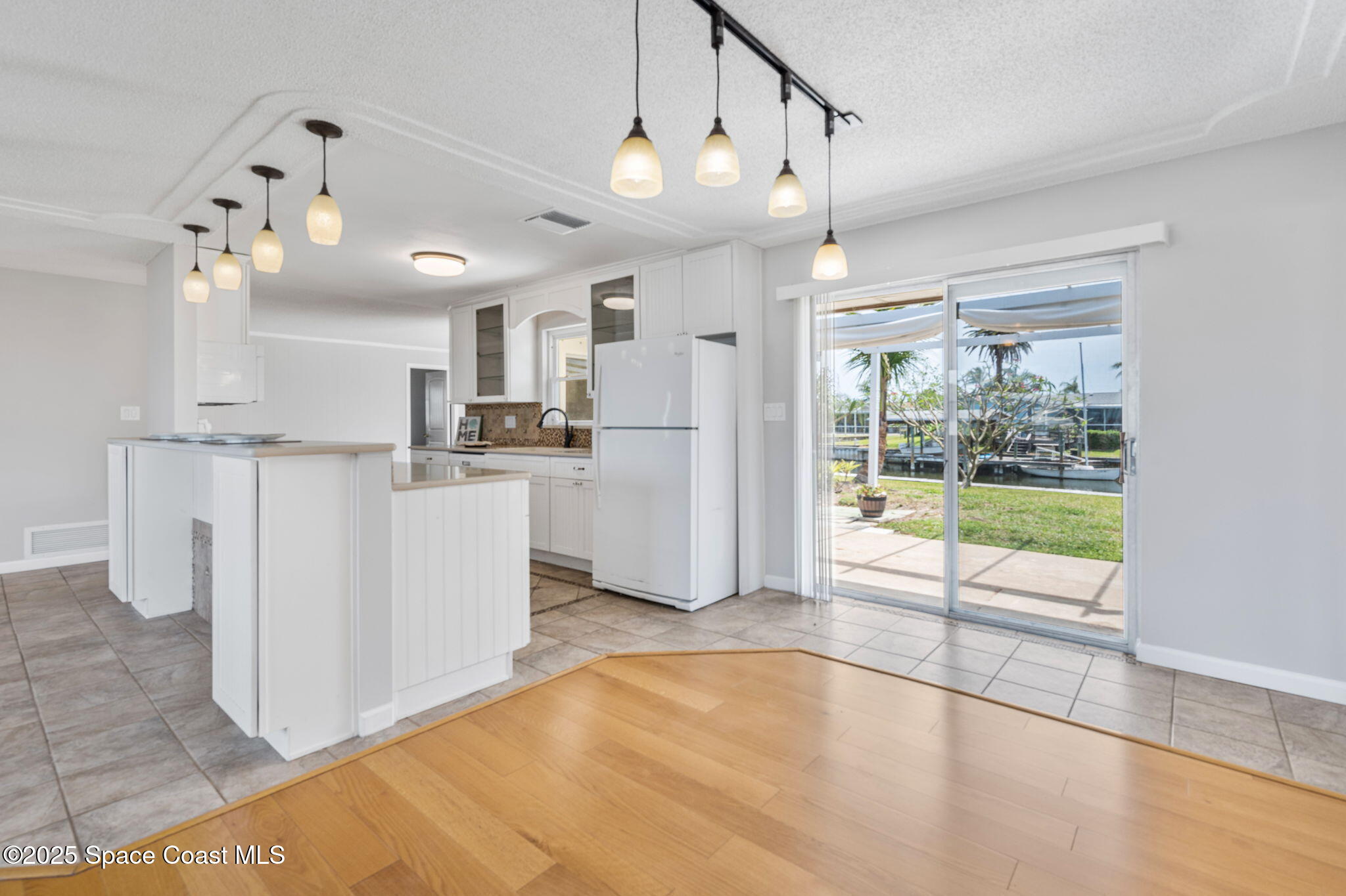 437 Eagle Drive Satellite Beach, FL 32937 - Photo 8 of 30 a view of a kitchen with counter top space and stainless steel appliances