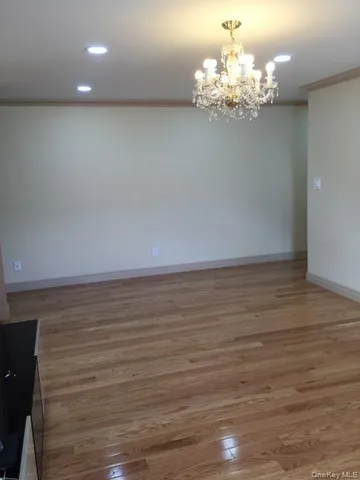 a view of a chandelier with wooden floor
