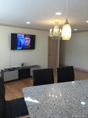 a living room with furniture chandelier and a chandelier