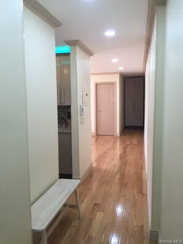 a view of hallway with wooden floor