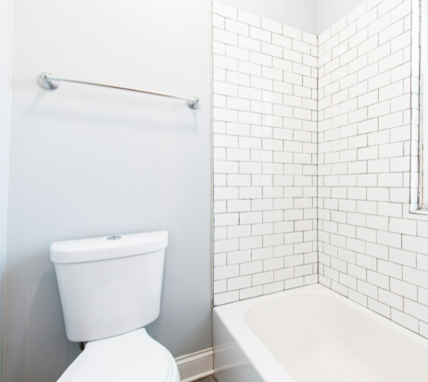 3614 West George Street, Unit 1R Chicago, IL 60618 - Photo 2 of 12 a white toilet sitting next to a bath tub