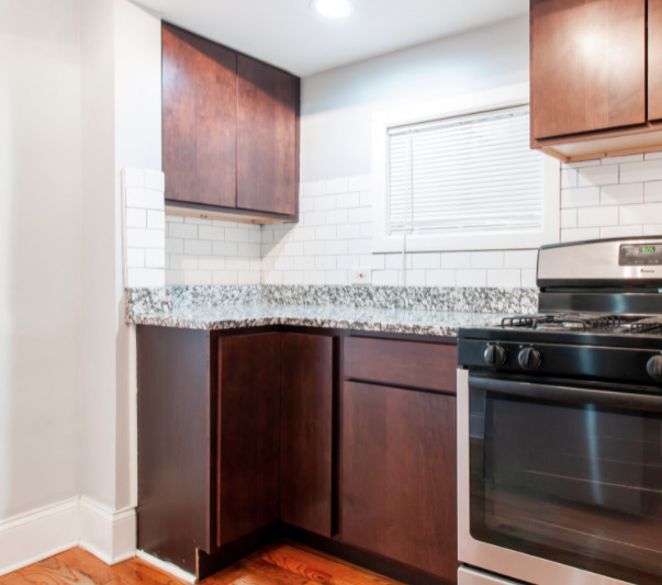 3614 West George Street, Unit 1R Chicago, IL 60618 - Photo 12 of 12 a kitchen with granite countertop cabinets stainless steel appliances and a counter space