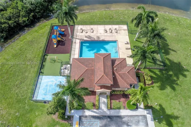 an aerial view of a house with yard swimming pool and outdoor seating