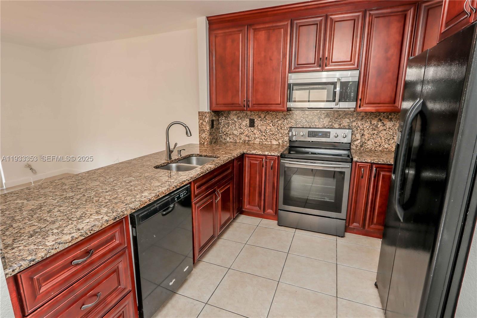 846 Southwest 148th Place Miami, FL 33194 - Photo 13 of 32 a kitchen with stainless steel appliances granite countertop a stove sink and cabinets