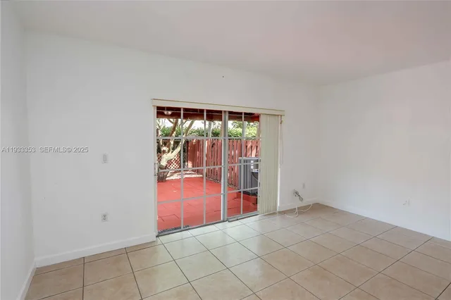a view of backyard with a large tree