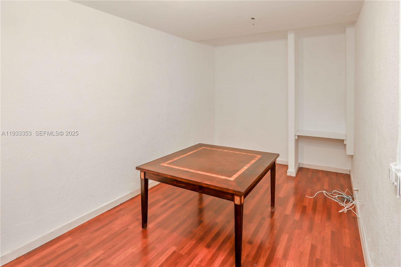 846 Southwest 148th Place Miami, FL 33194 - Photo 17 of 32 a room with a table and a wooden floor