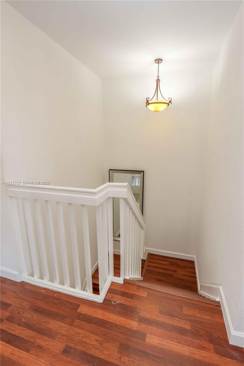 846 Southwest 148th Place Miami, FL 33194 - Photo 18 of 32 a bedroom with a bed and wooden floor