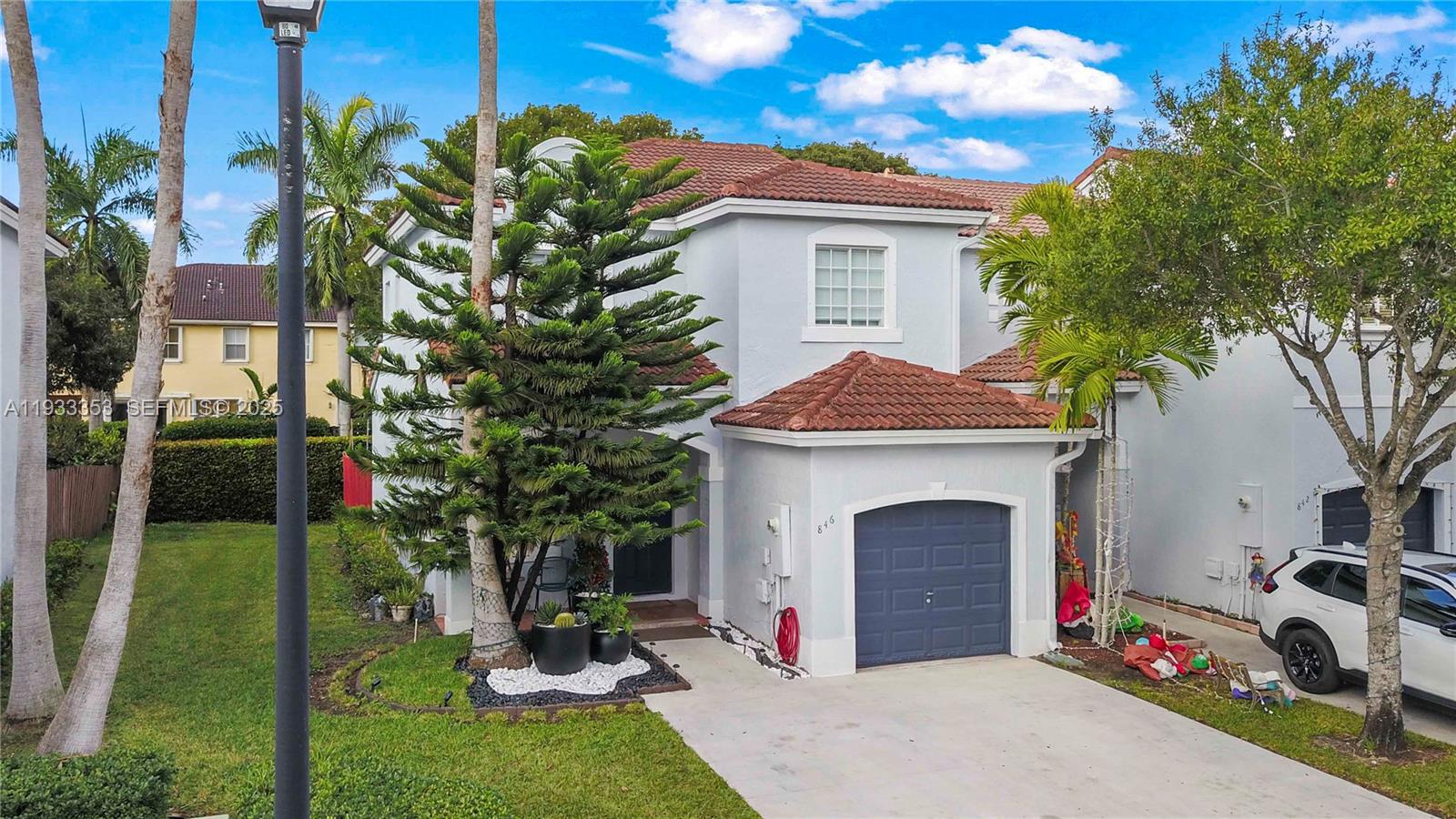 846 Southwest 148th Place Miami, FL 33194 - Photo 4 of 32 a front view of a house with garden