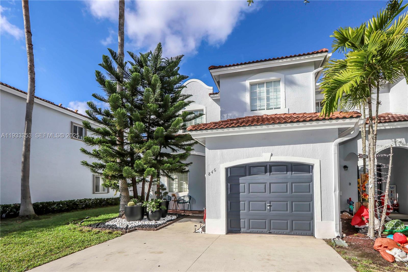 846 Southwest 148th Place Miami, FL 33194 - Photo 5 of 32 a front view of a house with a yard