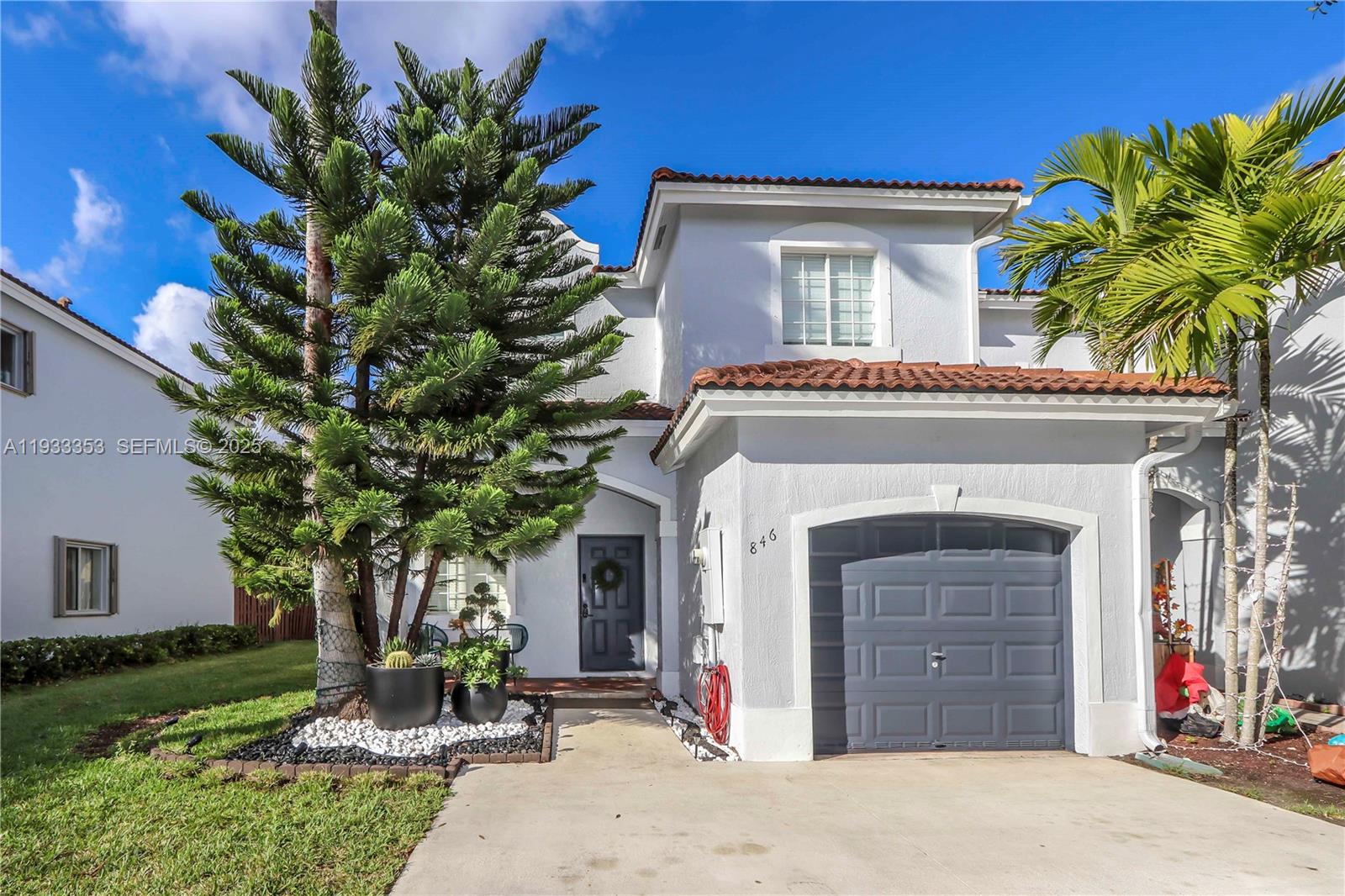 846 Southwest 148th Place Miami, FL 33194 - Photo 6 of 32 a front view of a house with a yard