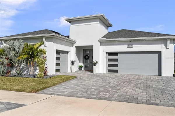 a front view of a house with a yard and garage