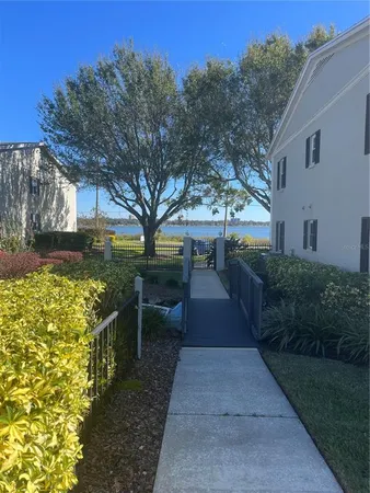a view of a patio with table and chairs with wooden fence and plants