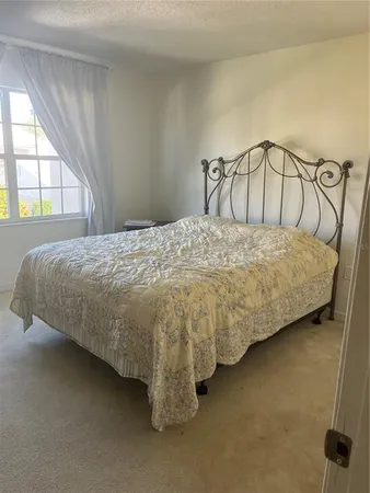 a bedroom with a bed and window