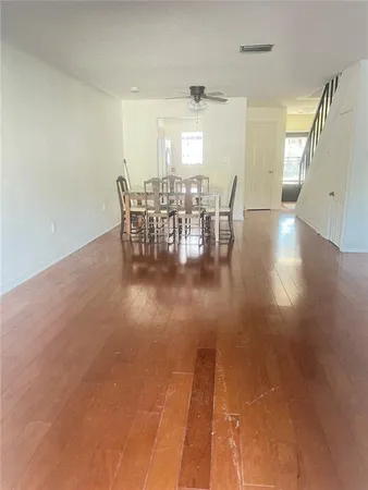 a dining room with furniture and wooden floor