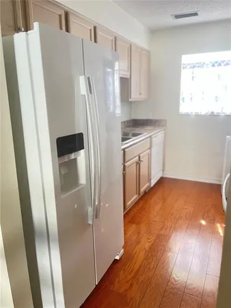 a kitchen with stainless steel appliances a refrigerator and a stove