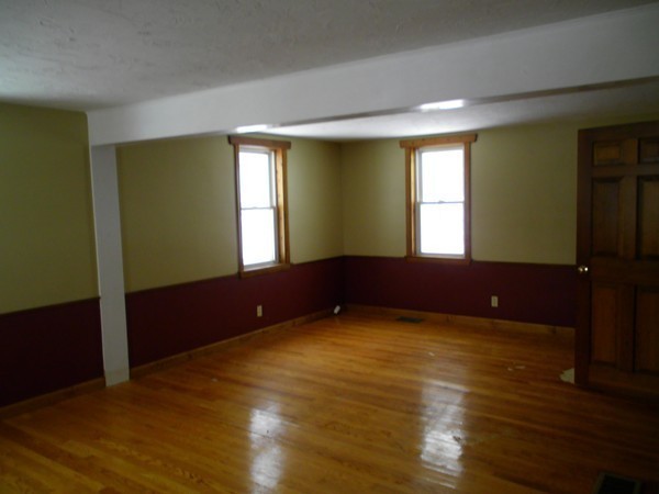 160 Draper Road East Brookfield, MA 01515 - Photo 6 of 19 a view of an empty room with wooden floor and a window