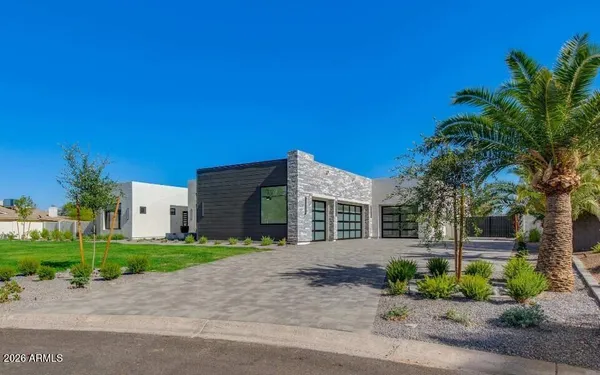 a front view of a house with a yard and a garage