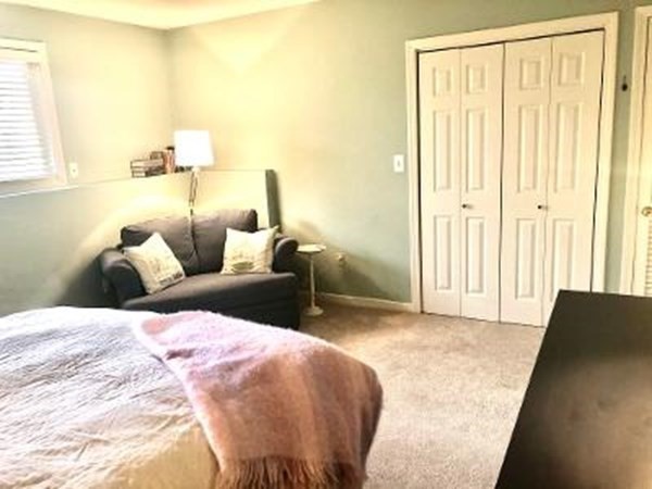 4873 Washington Street, Unit 1 Boston, MA 02132 - Photo 16 of 25 a bedroom with a bed and a window