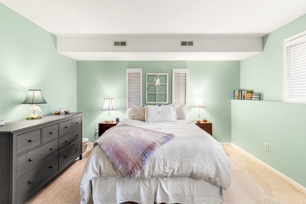 4873 Washington Street, Unit 1 Boston, MA 02132 - Photo 17 of 25 a bedroom with a bed and a dresser