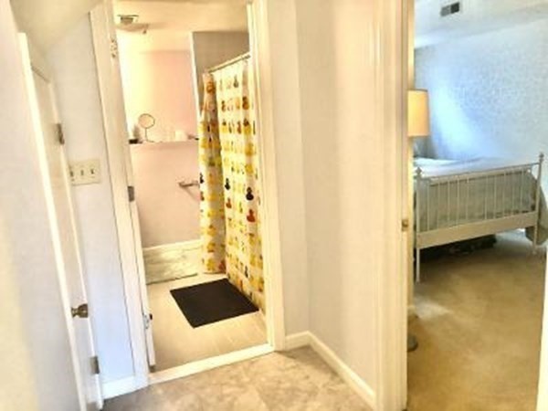 4873 Washington Street, Unit 1 Boston, MA 02132 - Photo 18 of 25 a bathroom with a tub and shower