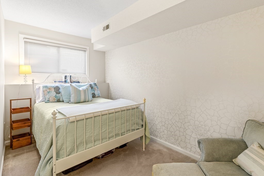 4873 Washington Street, Unit 1 Boston, MA 02132 - Photo 19 of 25 a bedroom with a bed and window