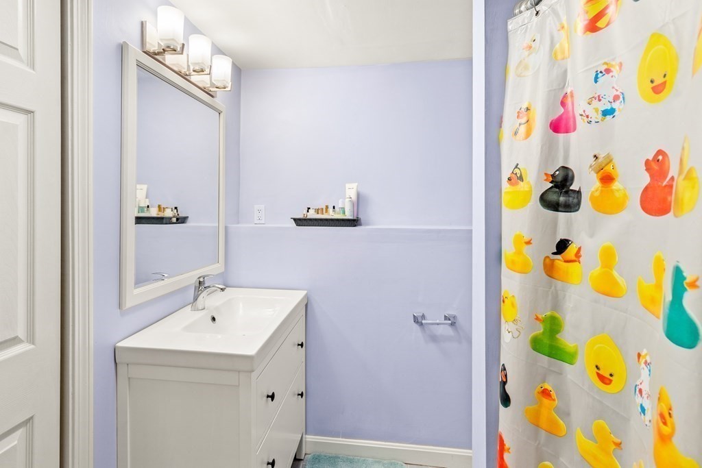 4873 Washington Street, Unit 1 Boston, MA 02132 - Photo 20 of 25 a bathroom with a sink and a mirror