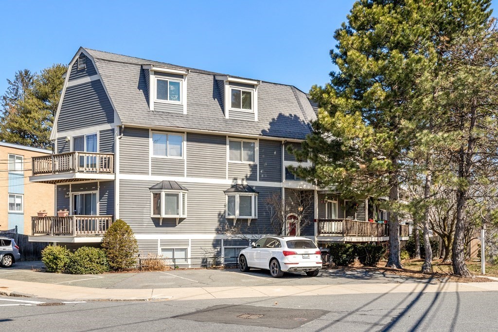 4873 Washington Street, Unit 1 Boston, MA 02132 - Photo 2 of 25 a car parked in front of a house