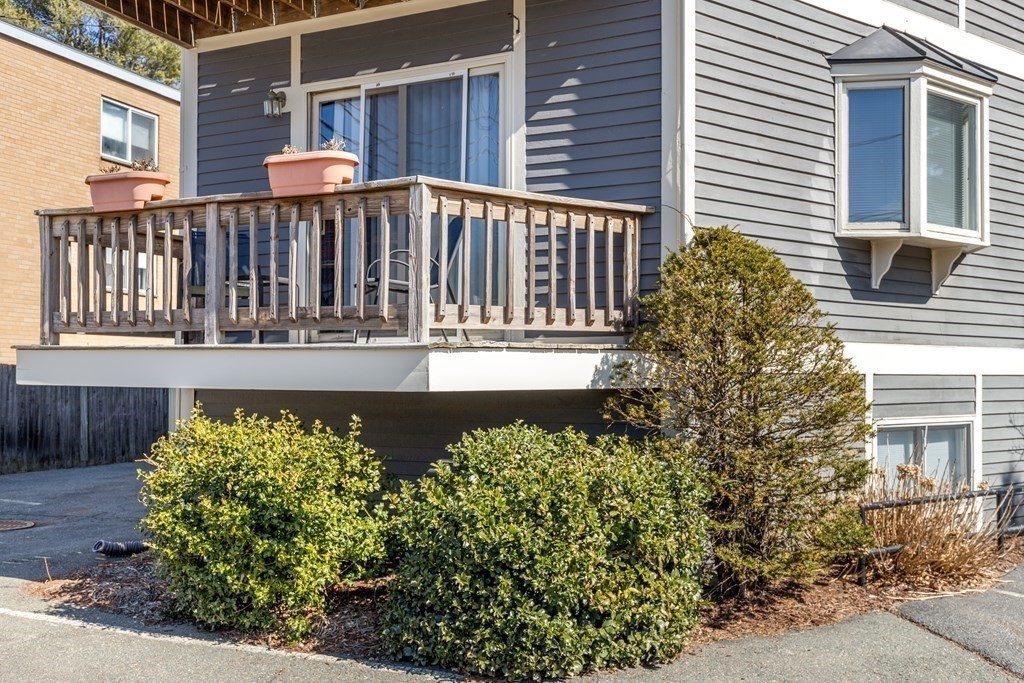 4873 Washington Street, Unit 1 Boston, MA 02132 - Photo 22 of 25 a front view of a house with a yard