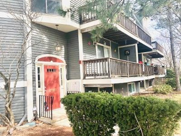 4873 Washington Street, Unit 1 Boston, MA 02132 - Photo 25 of 25 a front view of a house with a balcony
