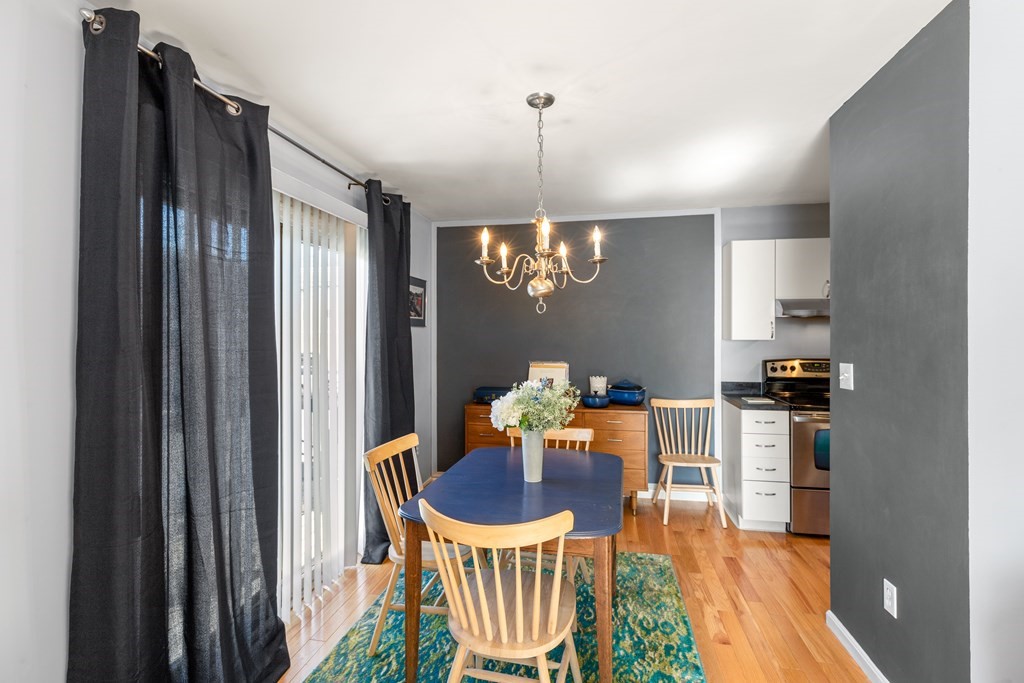 4873 Washington Street, Unit 1 Boston, MA 02132 - Photo 8 of 25 a view of a dining room with furniture window and wooden floor